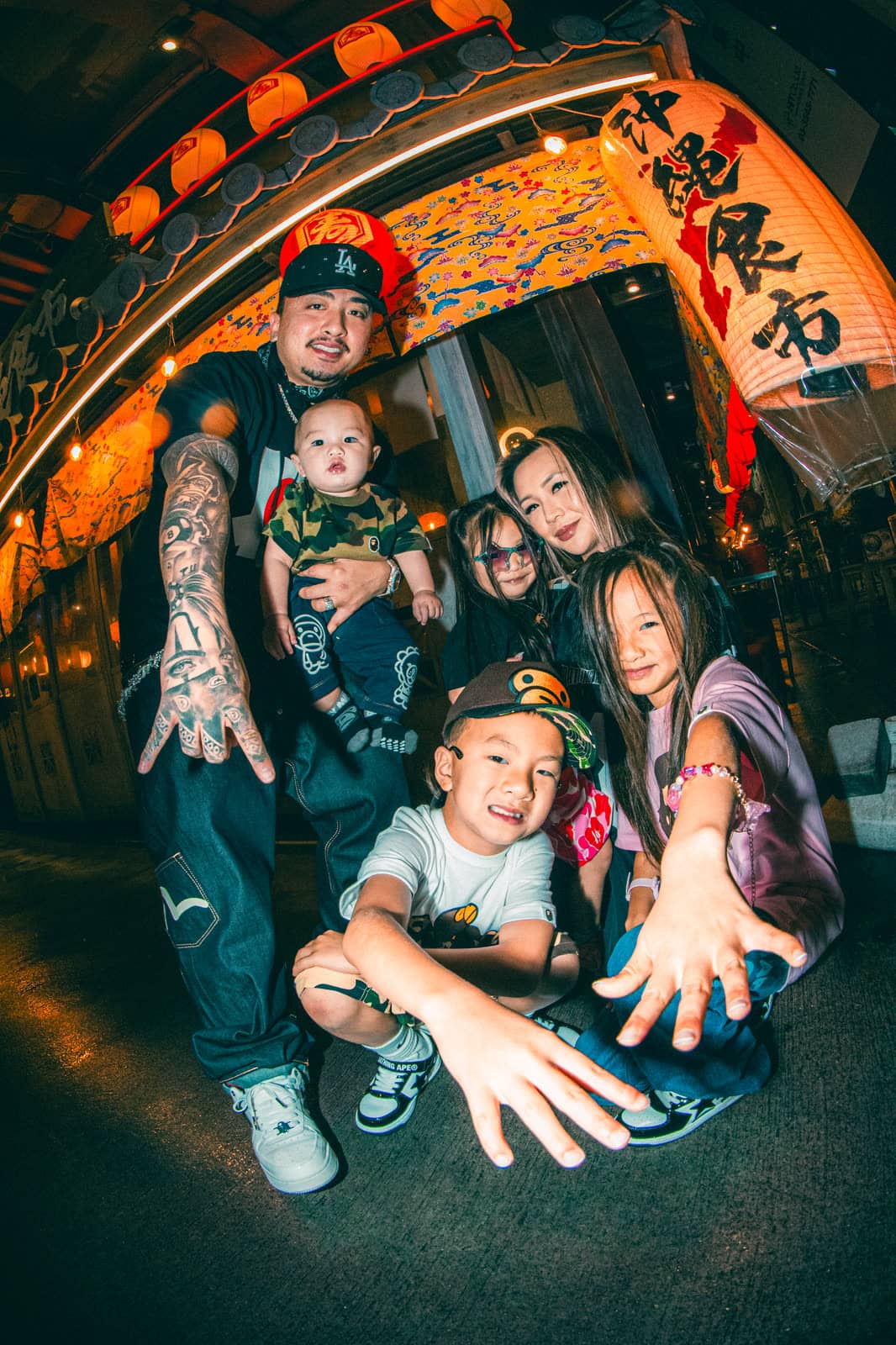 Family with three children under paper lanterns at night