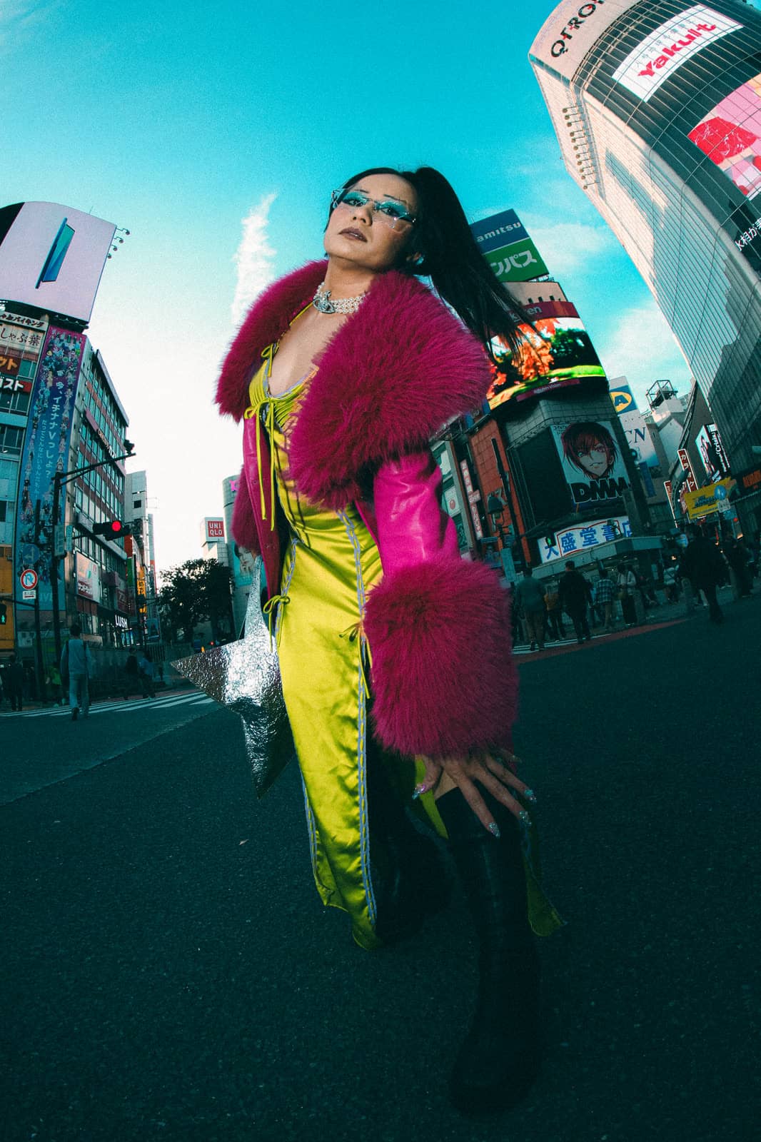 Woman in a pink fur coat among Tokyo billboards