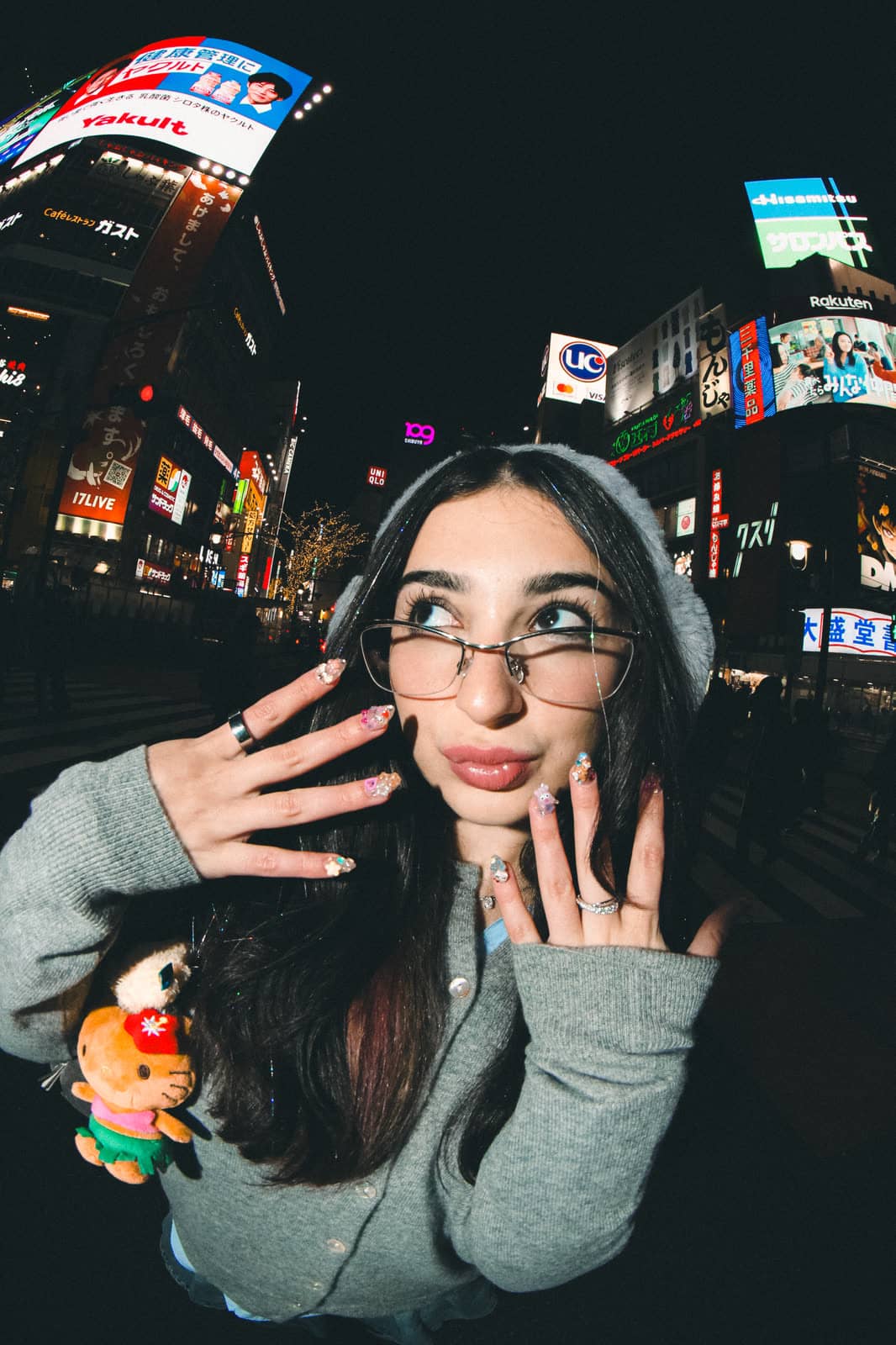 Woman in glasses on a neon-lit Tokyo street at night